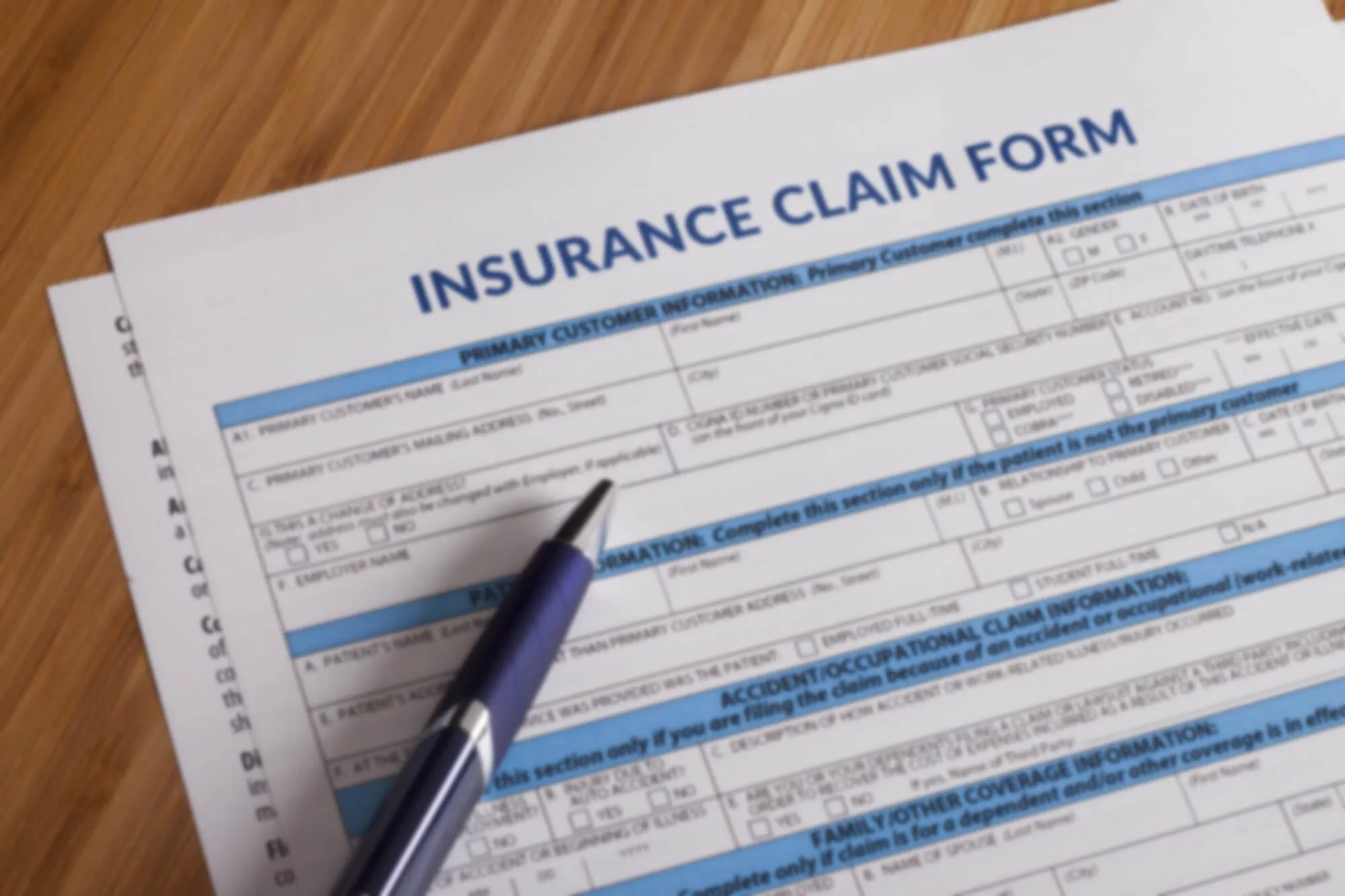 Insurance claim form and pen